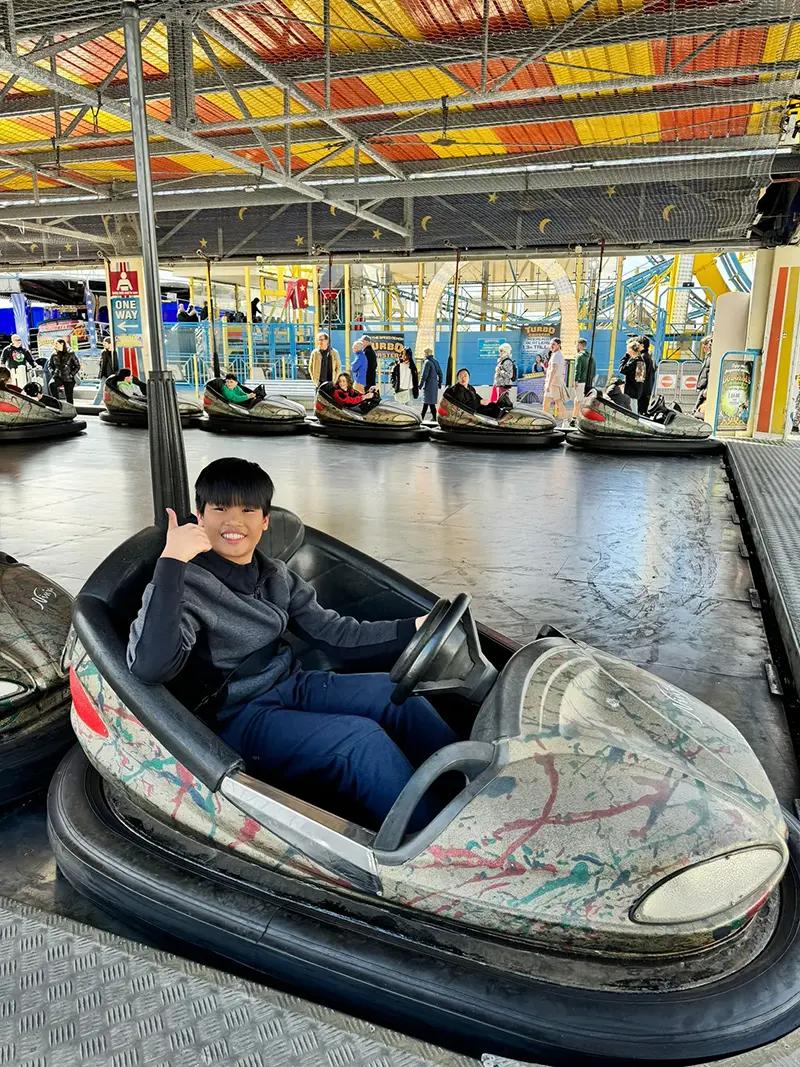 Student on bumper car on a school excursion