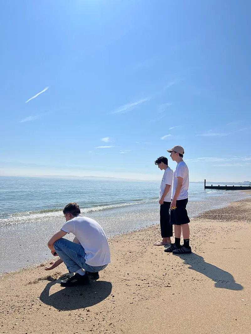 Students looking out to sea on a school excursion