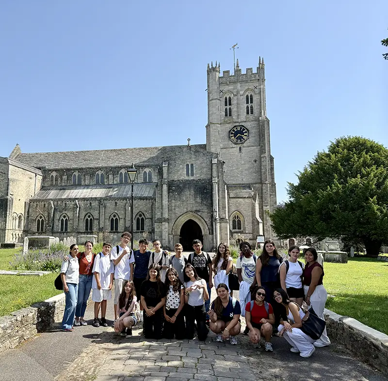 Students outside christchurch priory on a school excursion