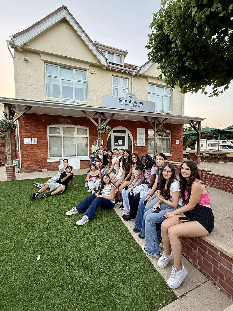 Students sat outside front of school on a school excursion