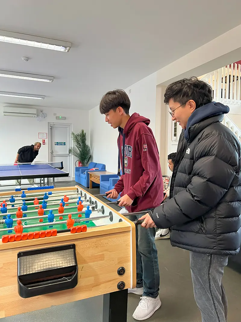 Students playing table football in student lounge 2 at Southbourne School