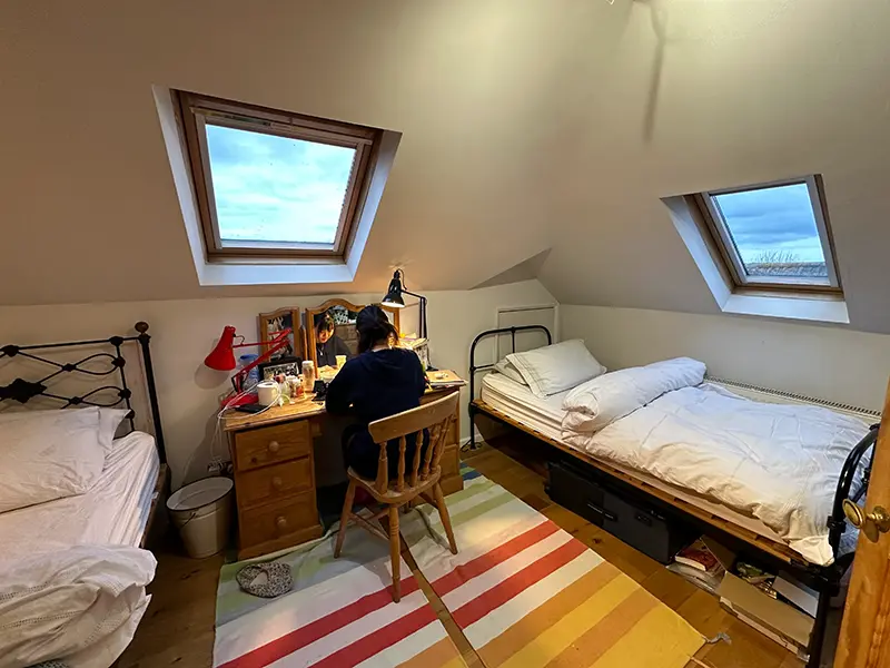 Student studying at a desk in bedroom