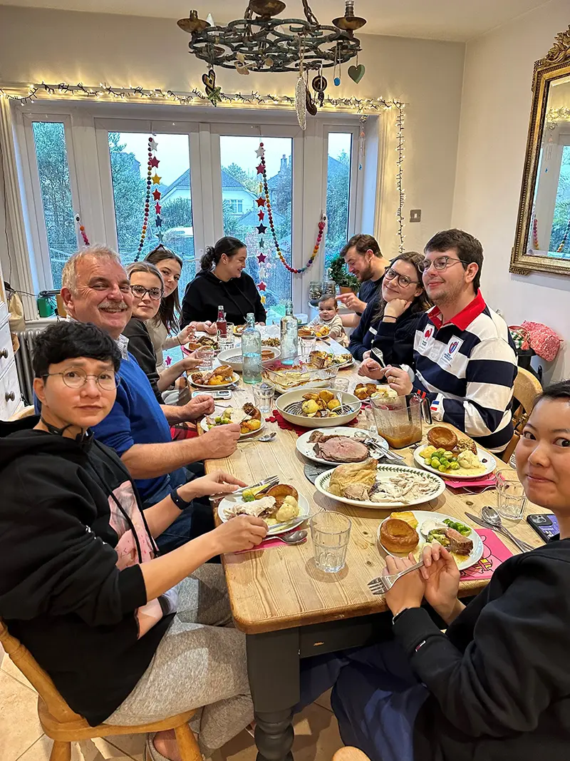 Homestay host eating dinner with students