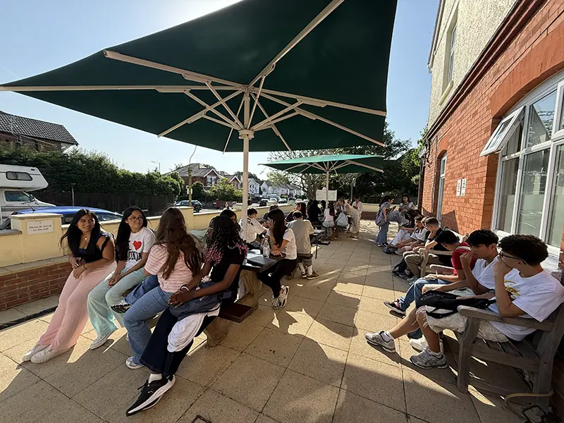 Students chatting in the front garden