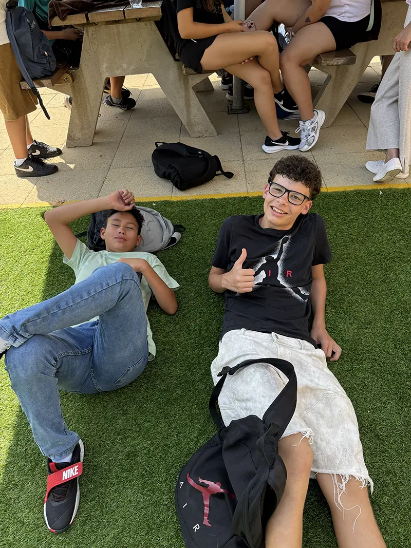 Students smiling and relaxing in the school garden